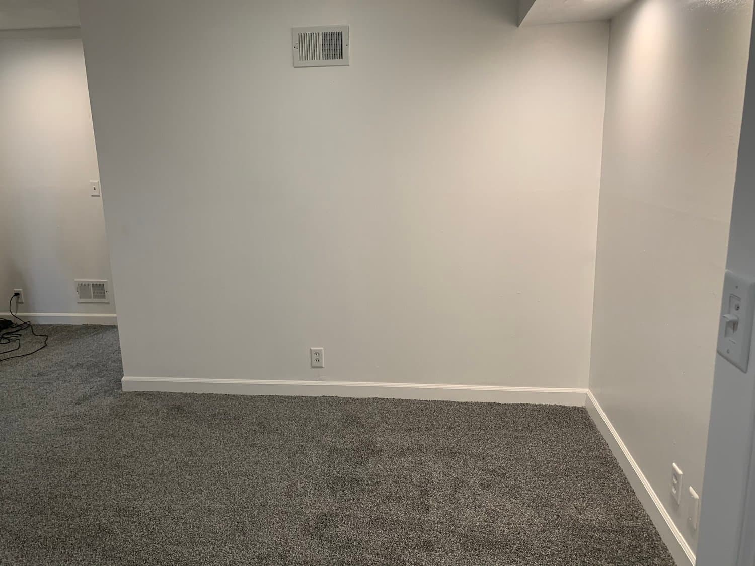 Small bedroom staged with a queen bed