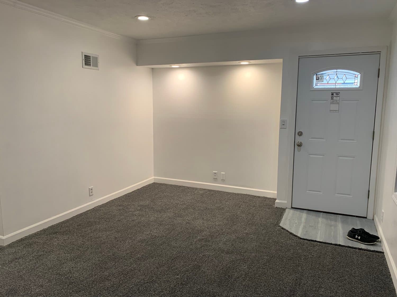 Open-concept living and dining area staged to define the space